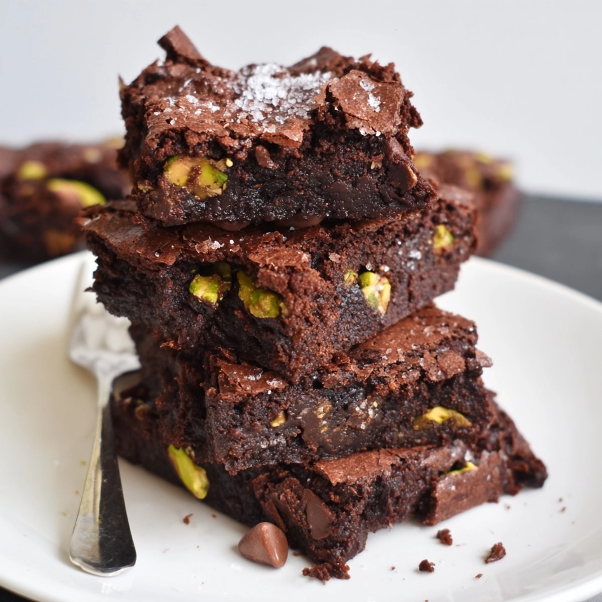 Fudgy Dubai Chocolate Pistachio Brownies, studded with green nuts, cooling on a wire rack.