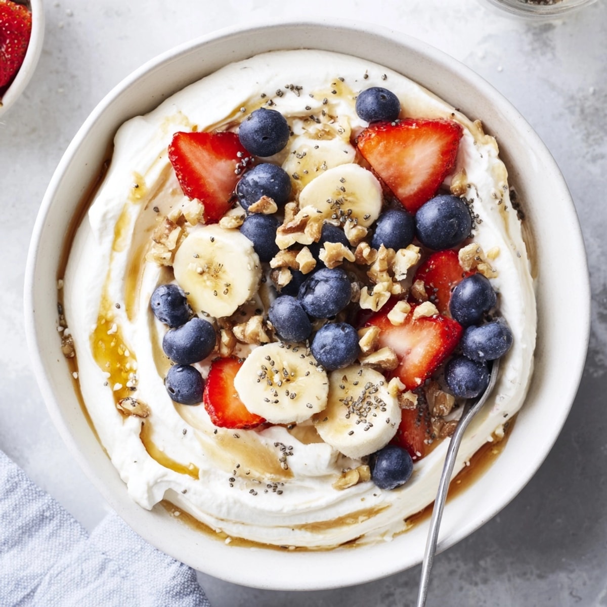 Scoops of Cottage Cheese High Protein Bowl with sweet fruit, ready to be devoured.