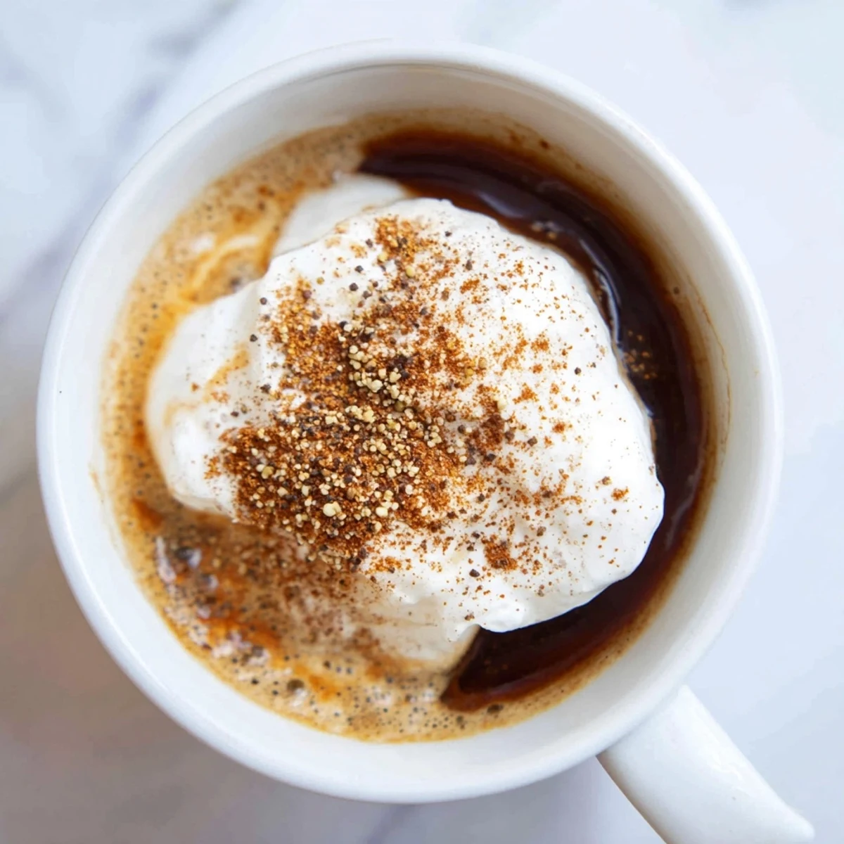 Warm, comforting Gingerbread Spiced Coffee, garnished with spices and ready for sipping.