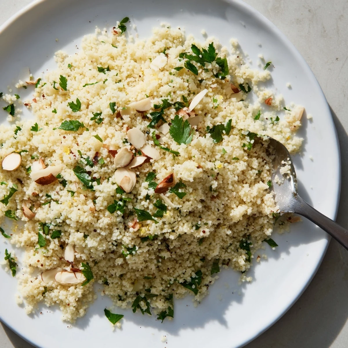 Fluffy couscous seasoned and ready to eat, a flavorful base for dishes like stews.