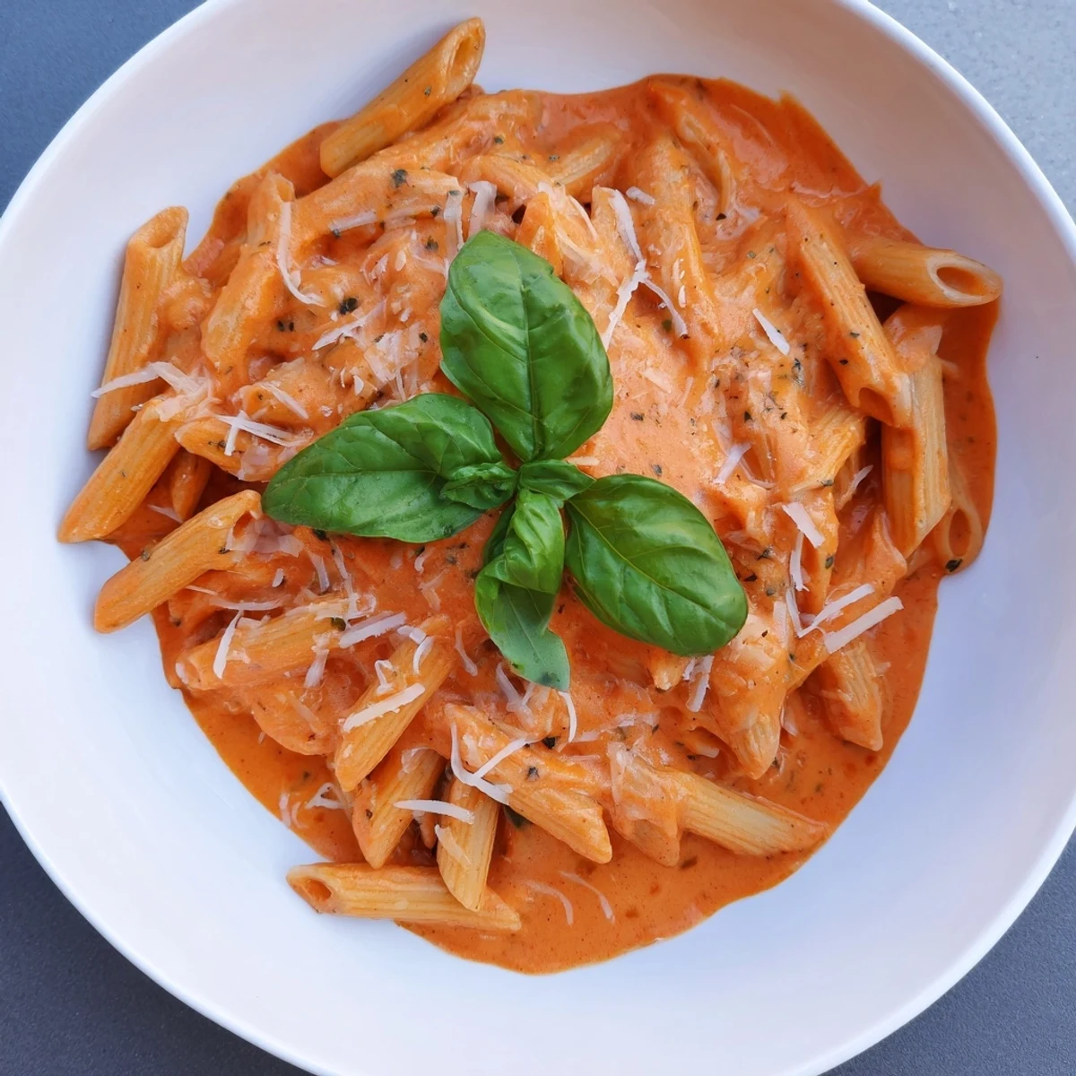 Creamy tomato pasta, a vibrant image showcasing the richness of the tomato sauce and fresh basil.