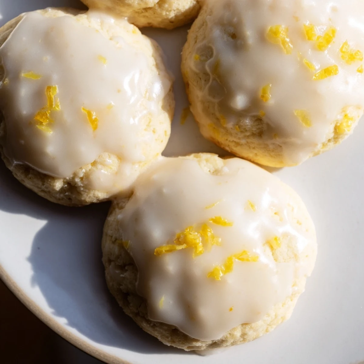 Freshly baked Lemon Ricotta Cookies, golden brown and glazed, perfect for sharing at a gathering.