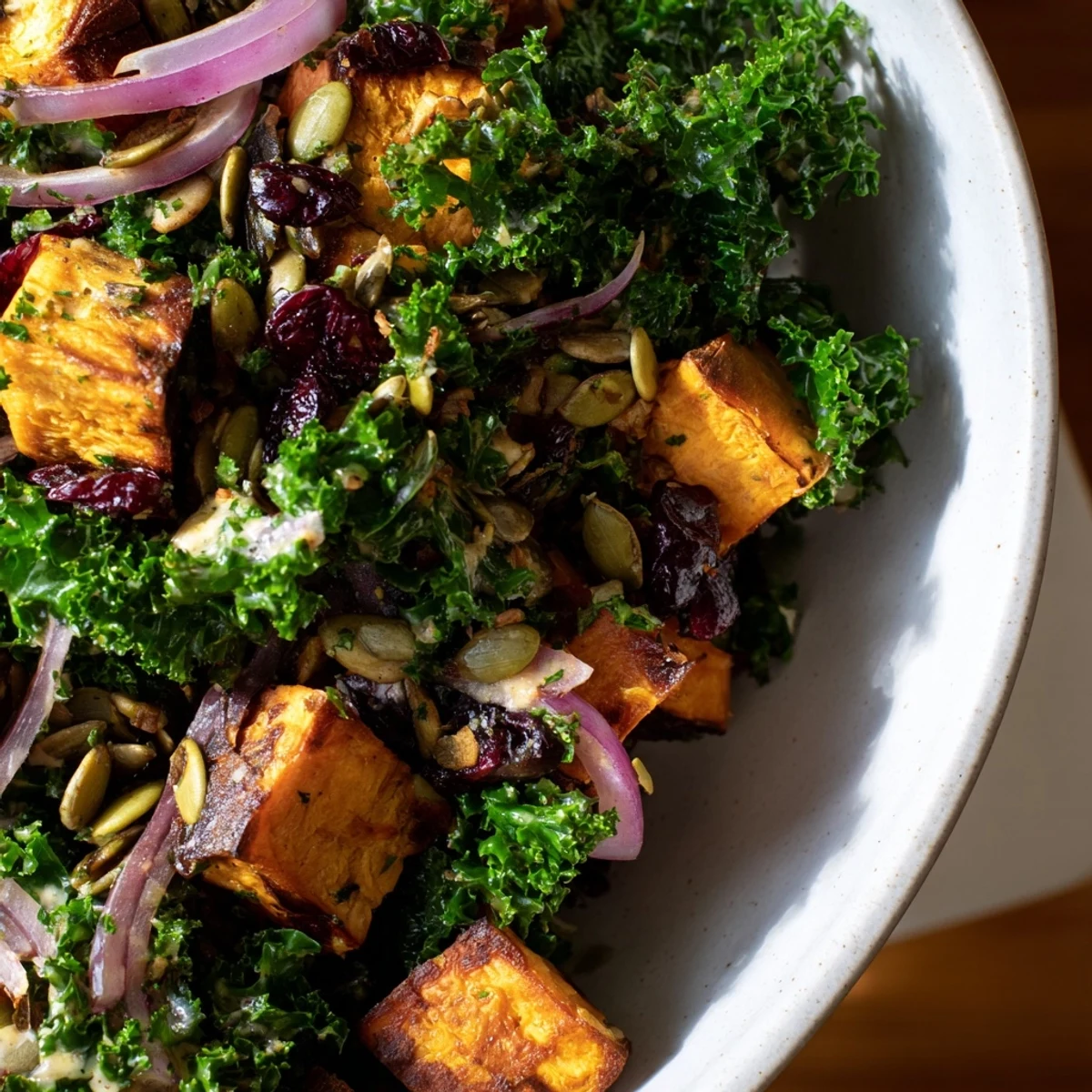 Roasted sweet potato cubes and massaged kale topped with toasted pepitas and cranberries, drizzled with creamy tahini dressing.