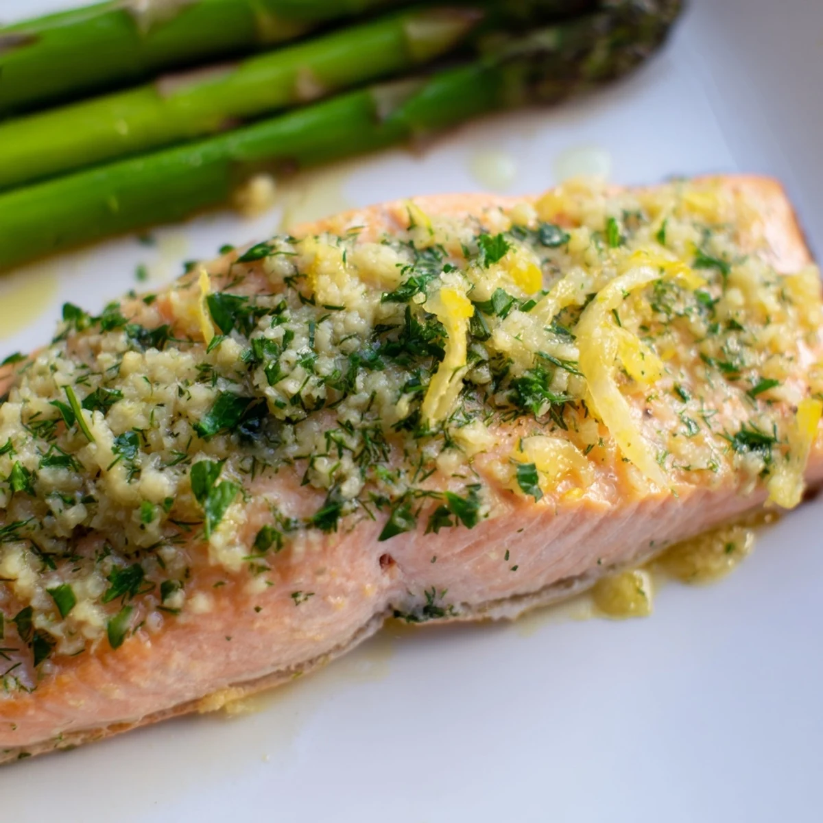 Flaky salmon coated in lemon garlic butter, served alongside tender roasted asparagus spears for dinner.
