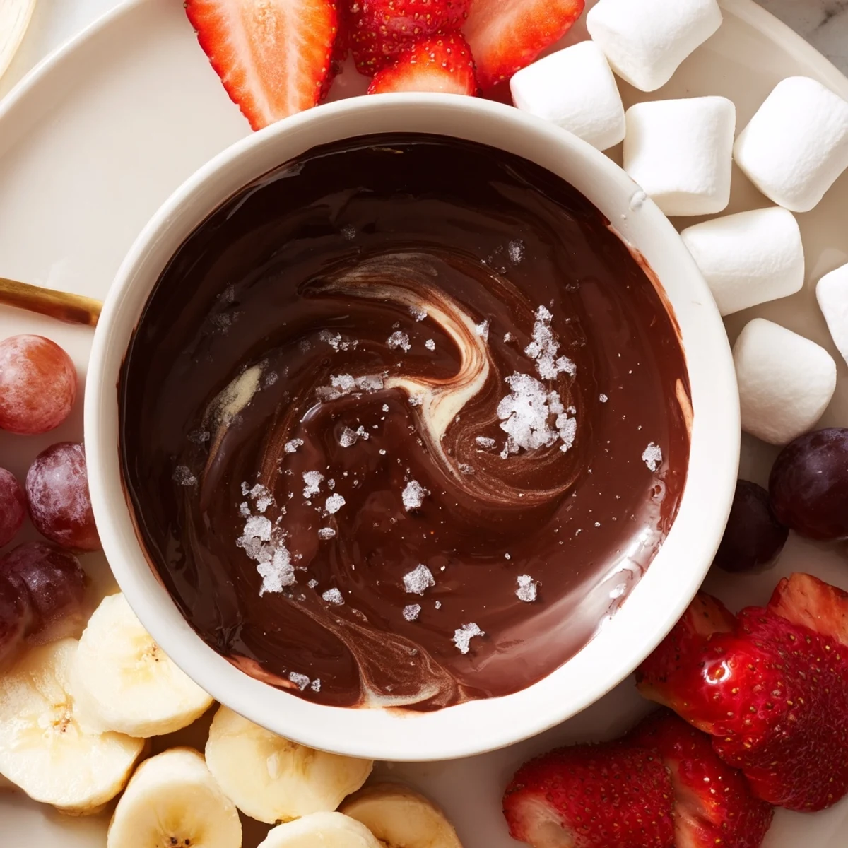 Silky melted chocolate fondue surrounds fluffy marshmallows and sliced bananas for dipping at a romantic gathering.