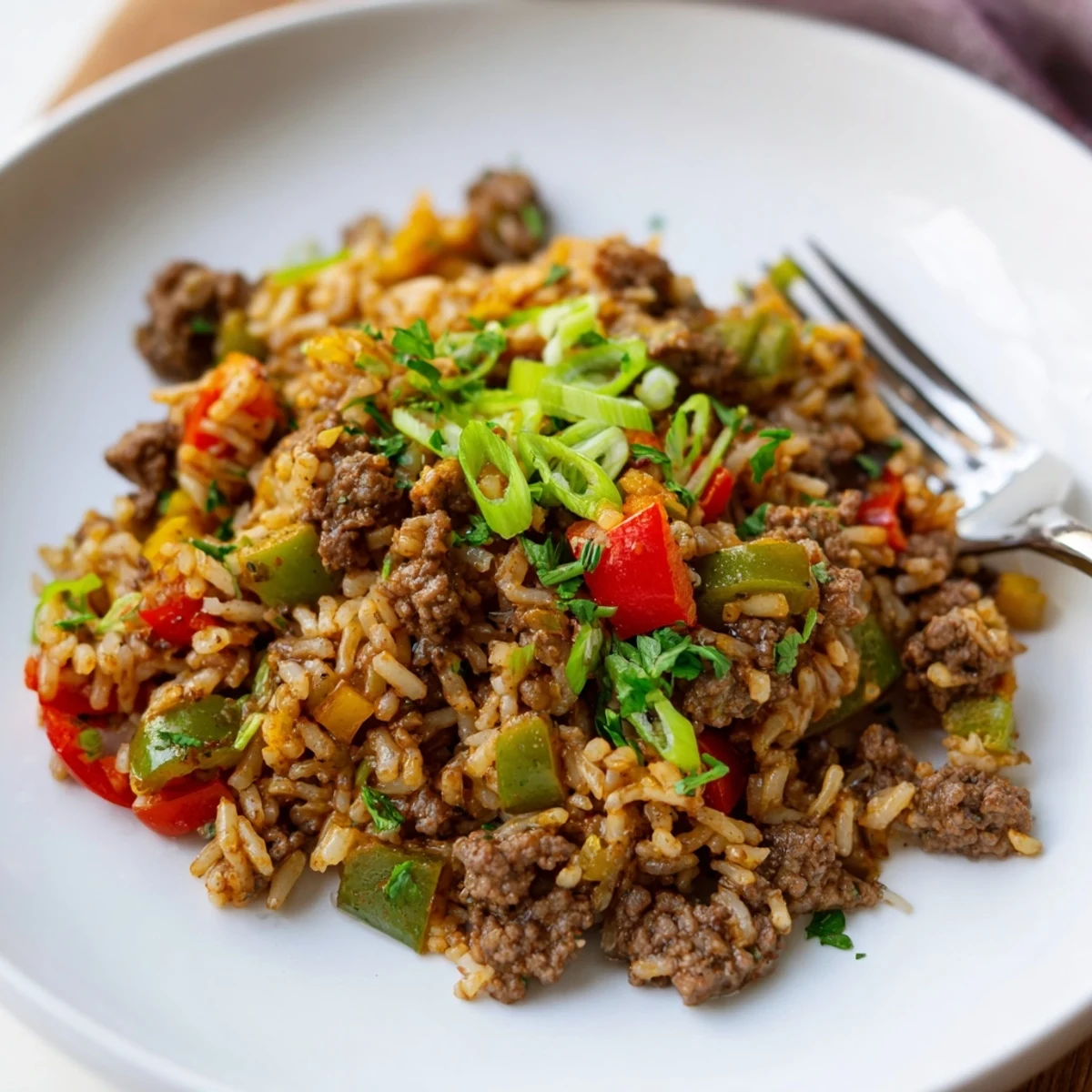 Close-up of Cajun Dirty Rice with Ground Beef and Peppers featuring vibrant bell peppers and savory ground beef.