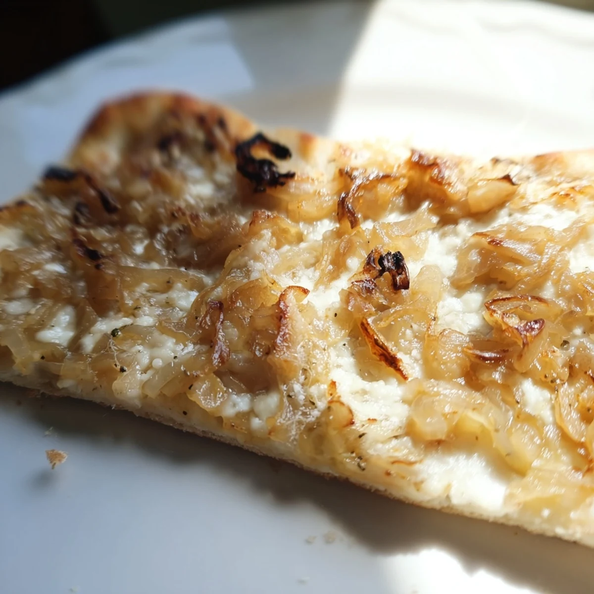 Serving suggestion for Caramelized Onion Pizza With Melty Cheese, featuring a crispy, golden-brown crust and fresh thyme garnish.  