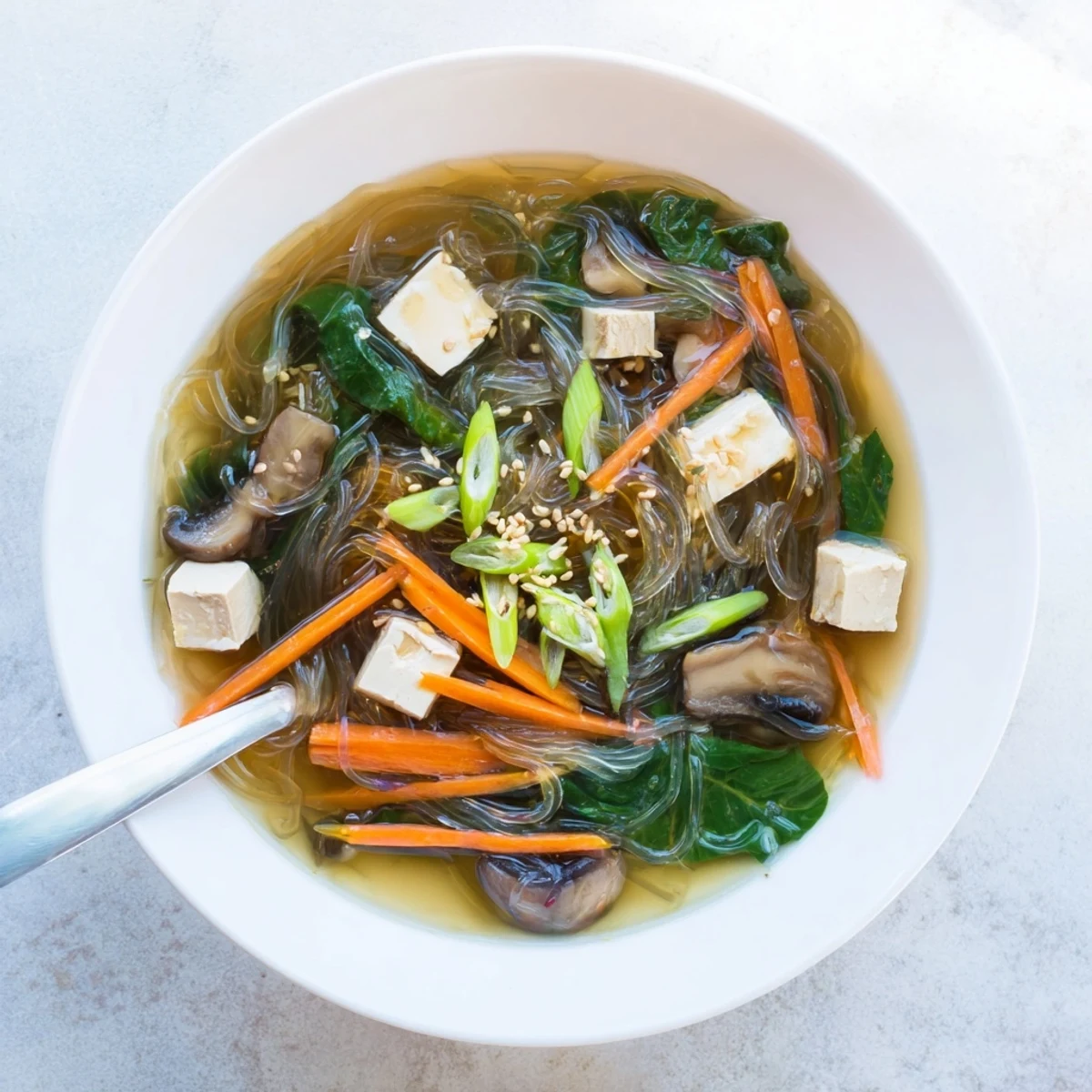 Bowl of Japanese Harusame Noodle Soup with tofu and spinach in dashi broth, perfect for a quick comforting dinner.