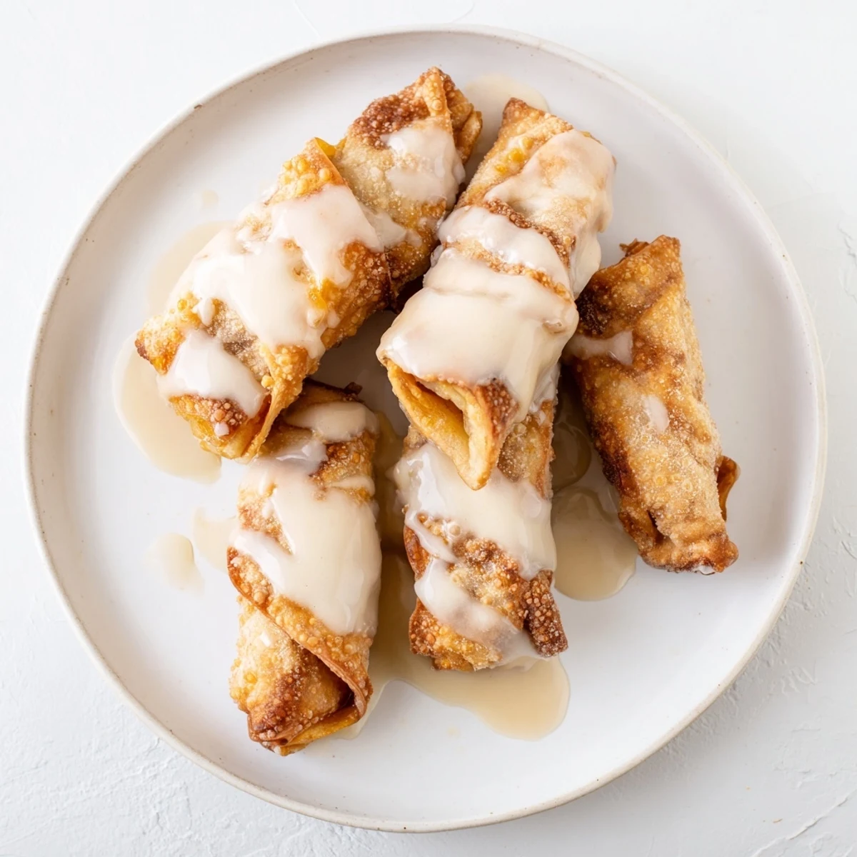 A close-up of Peach Cobbler Egg Rolls showing crispy wrappers and warm spiced peach filling ready to serve.