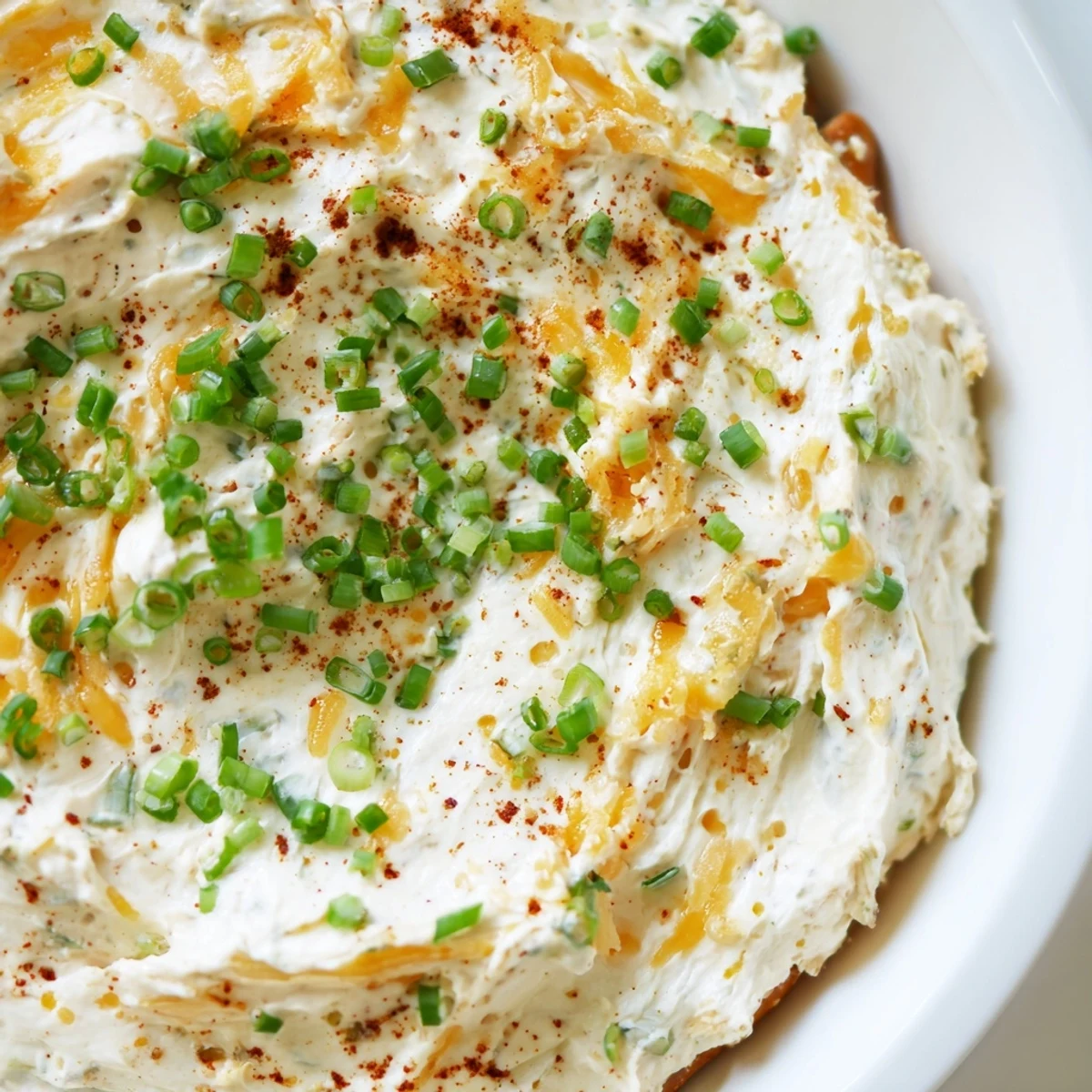 Creamy savory pretzel dip topped with fresh chives served alongside warm soft pretzels