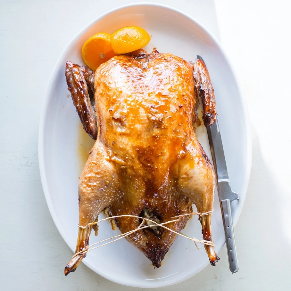 Holiday five spice roasted duck displaying glossy caramelized skin and tender carved meat