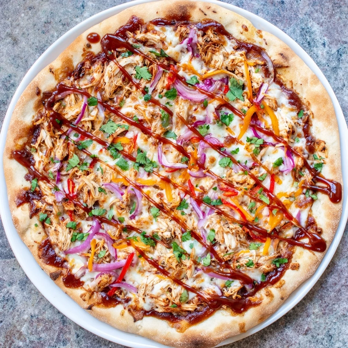 Golden homemade BBQ chicken pizza with smoky sauce, melted cheese, and colorful fresh vegetables baked to perfection