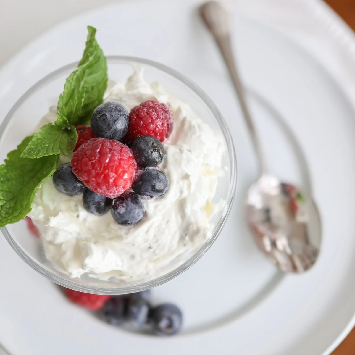 Elegant no bake lemon mascarpone mousse served chilled with mint garnish and fresh berries