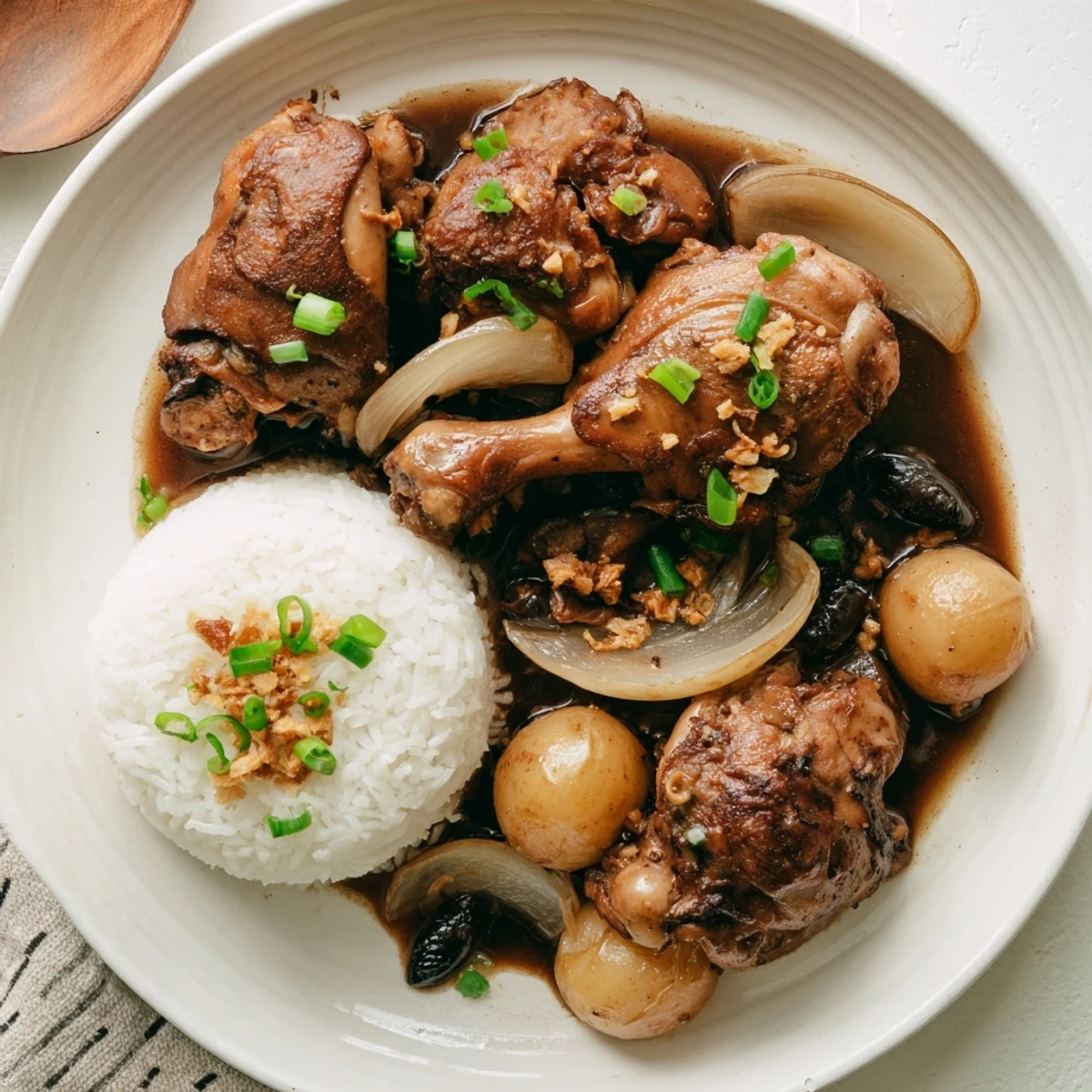 Savory Filipino Chicken Adobo featuring caramelized skin pieces served over fluffy jasmine rice