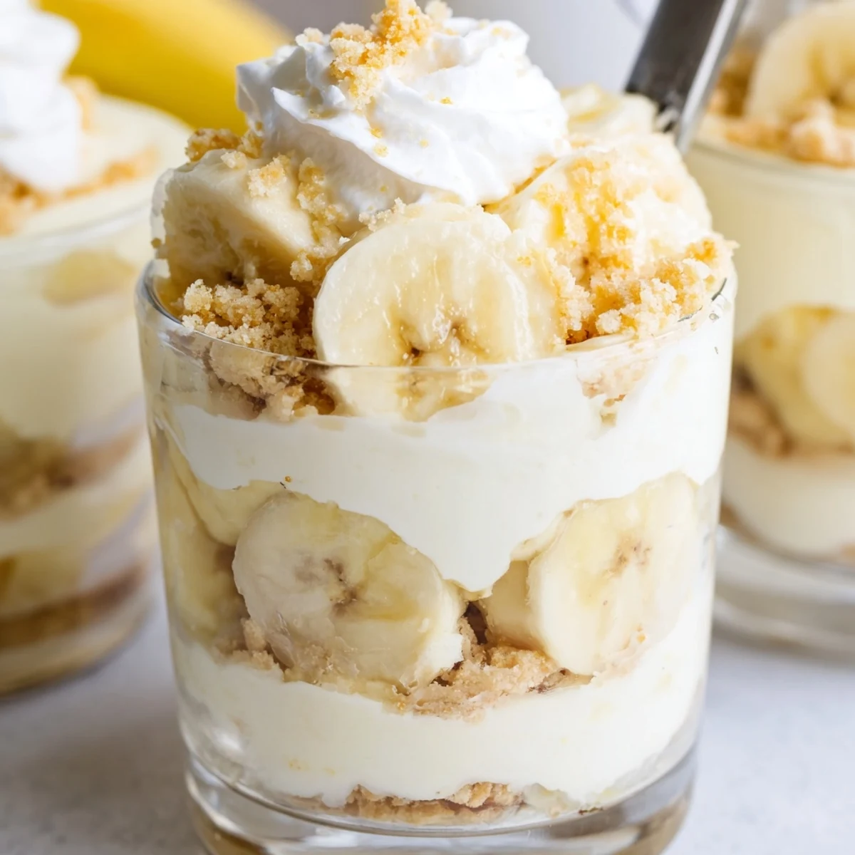Creamy no bake banana pudding cheesecake cups with layered vanilla wafer crust