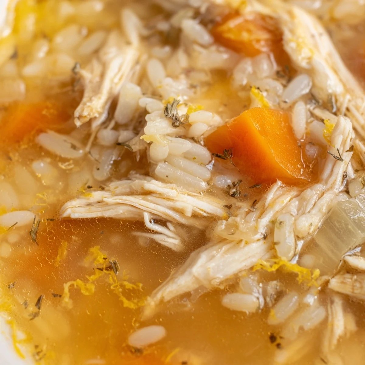 Golden Crockpot Lemon Chicken Soup loaded with tender shredded chicken and bright vegetables