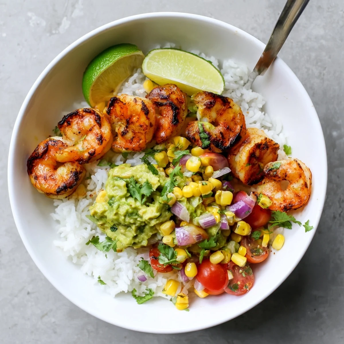Charred grilled shrimp bowl with avocado corn salsa over fluffy rice