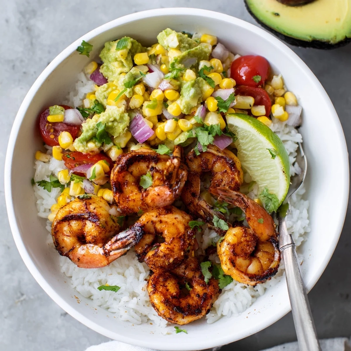 Smoky grilled shrimp bowl with avocado corn salsa served in a deep bowl