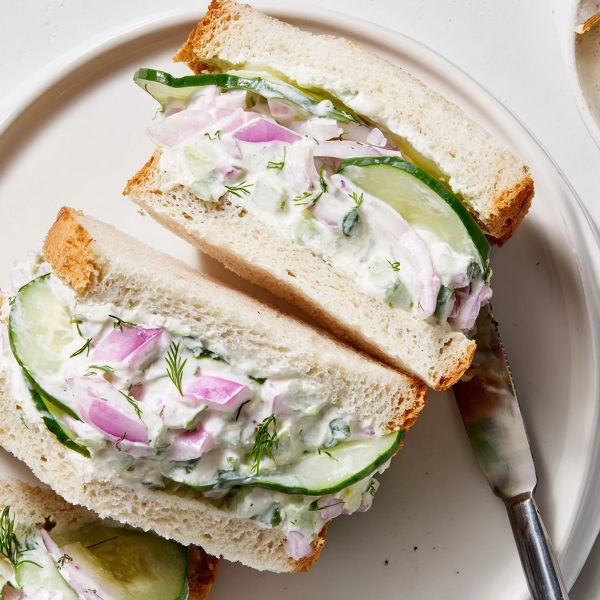 Layered Quick Cucumber Salad Sandwiches cut into halves, dill-scented, picnic-ready