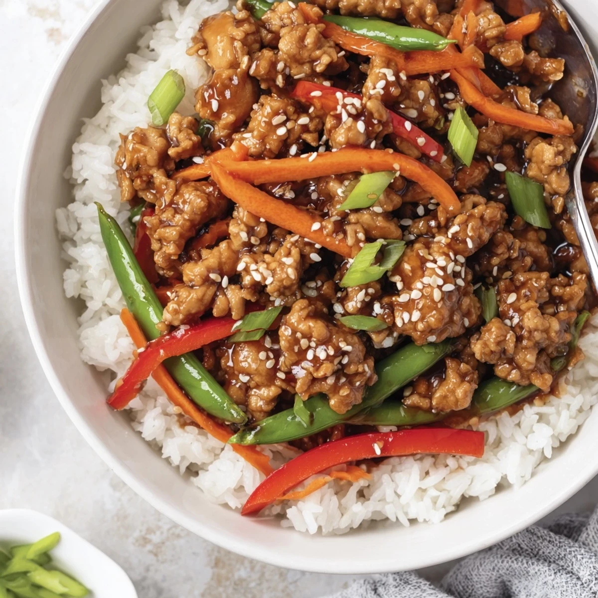Weeknight Teriyaki Turkey Rice Bowls served warm with sesame seeds and sriracha