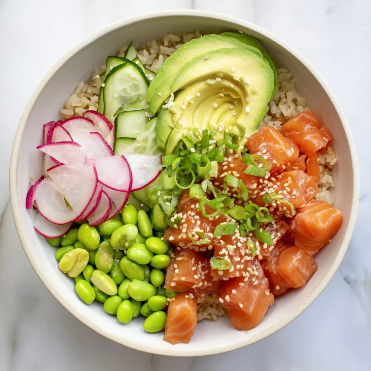 Fresh salmon and avocado poke bowl with colorful vegetables over seasoned rice