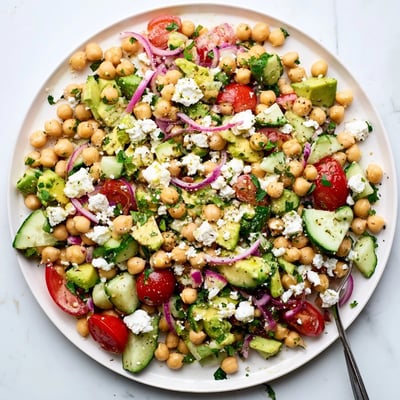 Healthy Mediterranean Chickpea Feta Avocado Salad with diced avocado, red onion, and chickpeas, ready to serve as a vibrant vegetarian lunch or dinner.